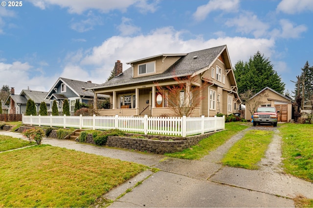 bungalow-style house with a fenced front yard, a chimney, a front yard, a residential view, and driveway