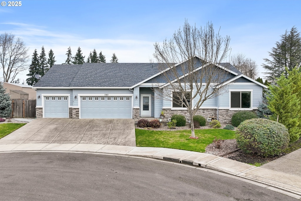 craftsman-style home with a garage and a front yard