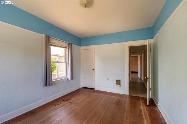 470 W 4th St, Coquille, OR 97423 - unfurnished bedroom with wood-type flooring, baseboards, and heating unit
