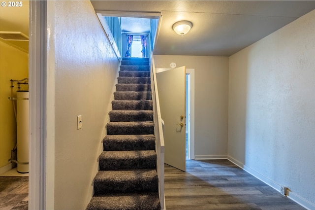 470 W 4th St, Coquille, OR 97423 - staircase with wood finished floors, water heater, and baseboards