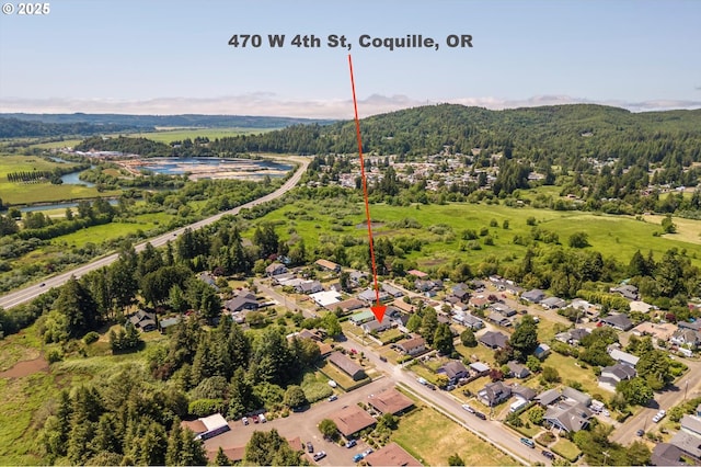 470 W 4th St, Coquille, OR 97423 - aerial view of residential area featuring a heavily wooded area and a large body of water