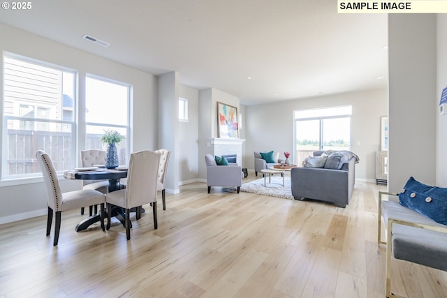 2216 Statesman Dr Lot 46, Woodland, WA 98674 - living area featuring a glass covered fireplace, healthy amount of natural light, light wood-style flooring, baseboards, and recessed lighting