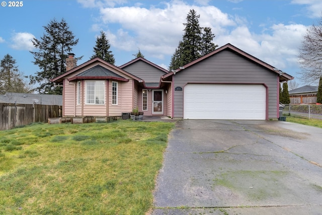 ranch-style house with a front yard, fence, a chimney, and an attached garage