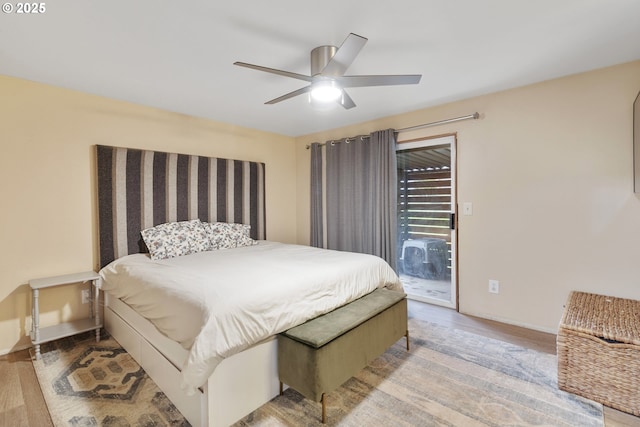 bedroom featuring access to outside, baseboards, ceiling fan, and wood finished floors