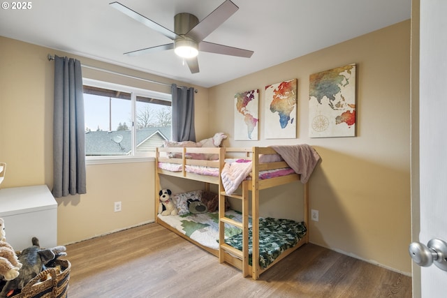 bedroom with a ceiling fan and wood finished floors