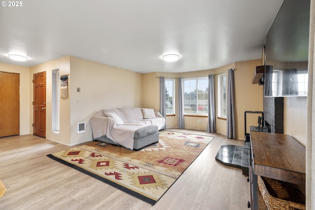 living room with visible vents and wood finished floors