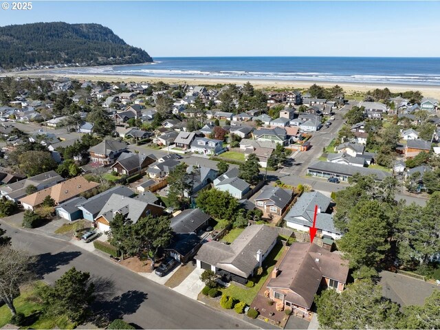 birds eye view of property with a beach view, a residential view, and a water view