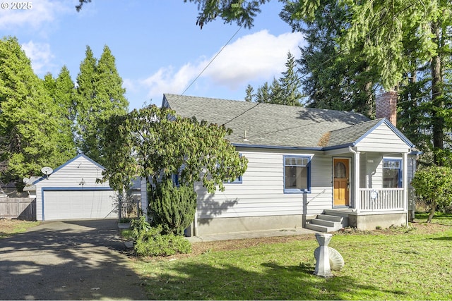 view of front of house featuring a garage, a chimney, roof with shingles, fence, and a front yard