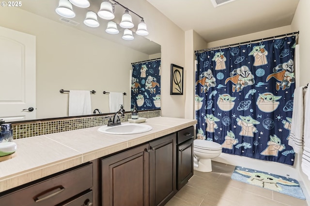 10183 NW Crossing Dr, Portland, OR 97229 - full bathroom with vanity, toilet, tile patterned flooring, and a shower with shower curtain
