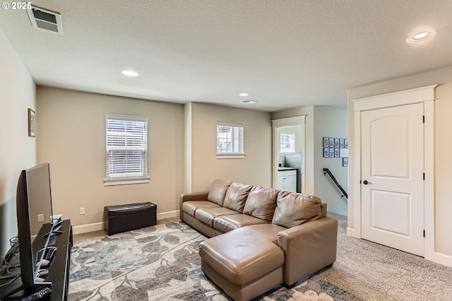 10183 NW Crossing Dr, Portland, OR 97229 - living room featuring light colored carpet, recessed lighting, a textured ceiling, and baseboards