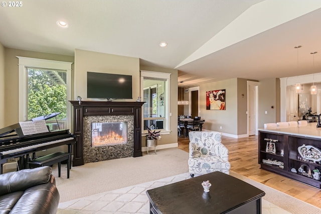 10183 NW Crossing Dr, Portland, OR 97229 - living area with vaulted ceiling, a tiled fireplace, baseboards, light wood-style floors, and recessed lighting