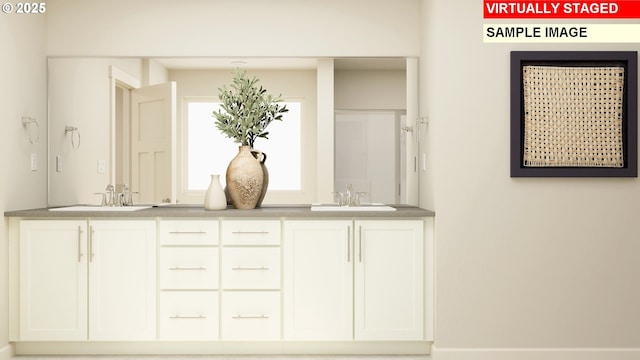 interior space featuring white cabinetry and sink