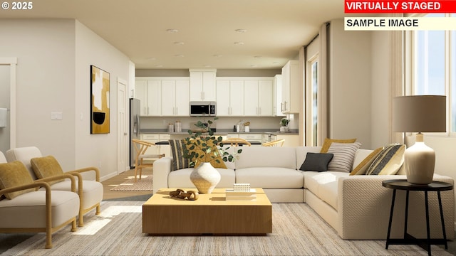 living room featuring light wood finished floors and baseboards