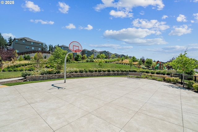 view of patio with basketball hoop and a playground