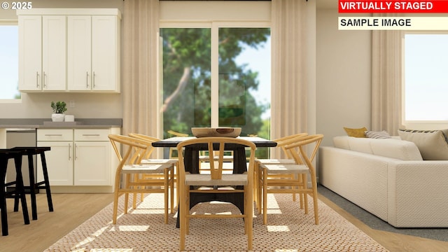 dining space with a wealth of natural light and light wood-style floors