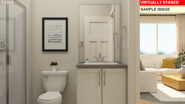 bathroom featuring a shower with door, vanity, and toilet