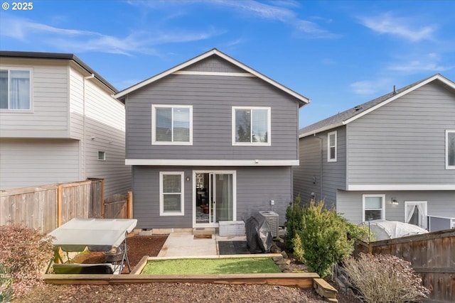 rear view of property with a patio area and fence