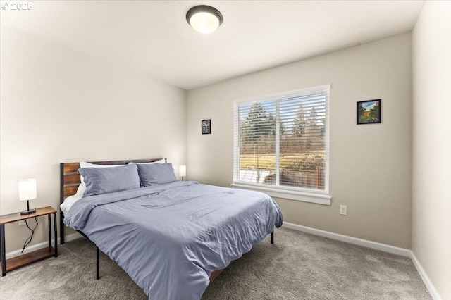 bedroom featuring carpet and baseboards