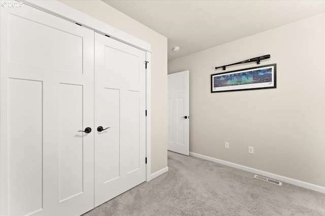 12977 SE Creekside Ter, Happy Valley, OR 97086 - unfurnished bedroom with light carpet, baseboards, and a closet
