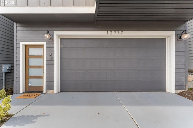 garage featuring concrete driveway