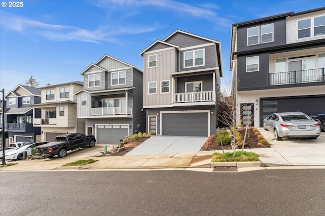 townhome / multi-family property with driveway, an attached garage, a residential view, and board and batten siding