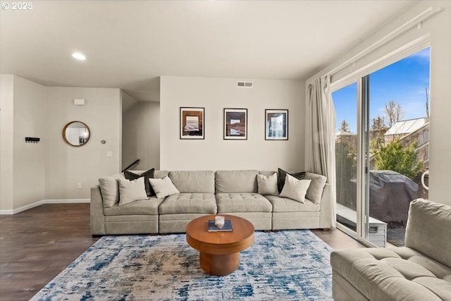 living area with recessed lighting, wood finished floors, visible vents, and baseboards