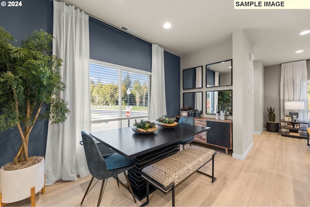 dining area with light hardwood / wood-style flooring