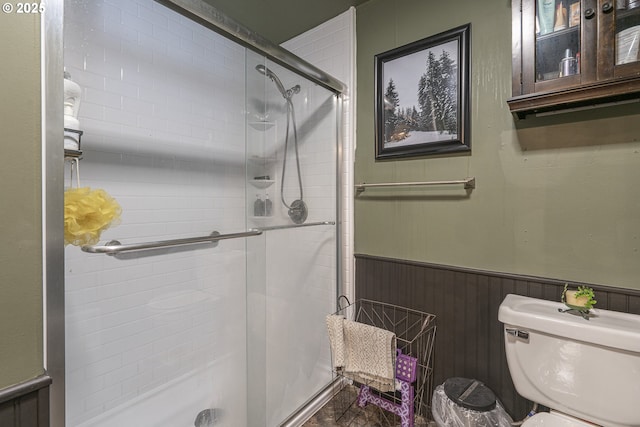1646 E Gibbs Ave, Cottage Grove, OR 97424 - bathroom featuring toilet, a shower stall, and a wainscoted wall
