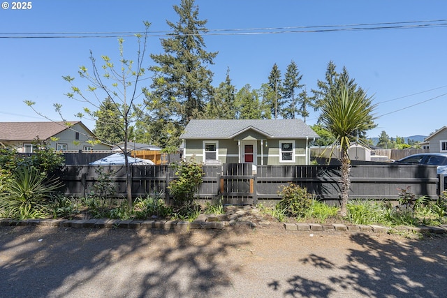 1646 E Gibbs Ave, Cottage Grove, OR 97424 - bungalow featuring a residential view, a fenced front yard, and a gate