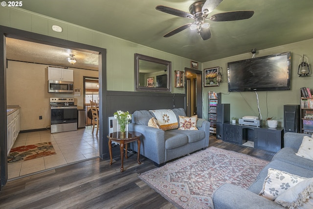 1646 E Gibbs Ave, Cottage Grove, OR 97424 - living room featuring crown molding, ceiling fan, wood finished floors, and a decorative wall