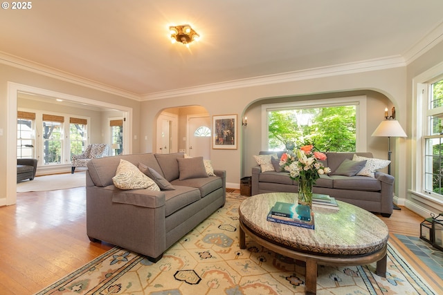 4052 NE 22nd Ave, Portland, OR 97212 - living room featuring arched walkways, ornamental molding, and light wood-type flooring