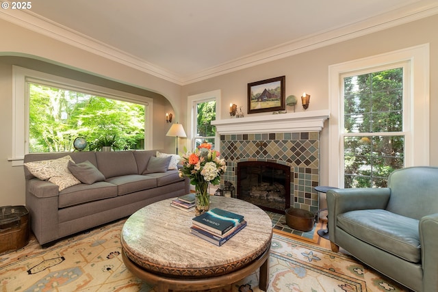 4052 NE 22nd Ave, Portland, OR 97212 - living room with crown molding, healthy amount of natural light, a tiled fireplace, and light wood-style floors