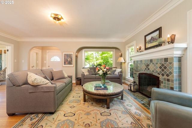 4052 NE 22nd Ave, Portland, OR 97212 - living area featuring arched walkways, ornamental molding, light wood-style flooring, and a fireplace