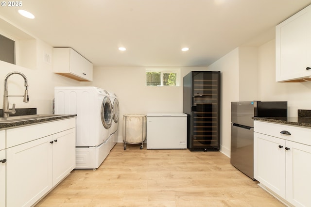 4052 NE 22nd Ave, Portland, OR 97212 - laundry area with washer and clothes dryer, light wood finished floors, recessed lighting, beverage cooler, and cabinet space