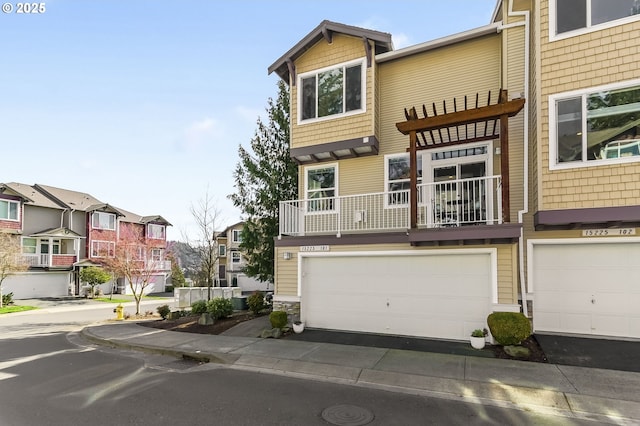 townhome / multi-family property with a garage and a residential view