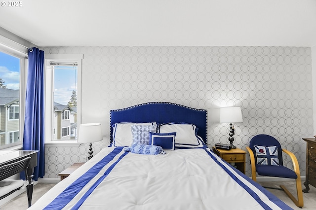 bedroom featuring wallpapered walls and baseboards