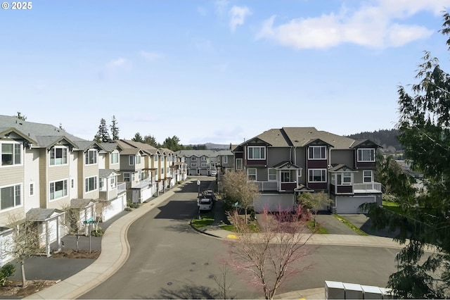 view of road featuring curbs, a residential view, and sidewalks