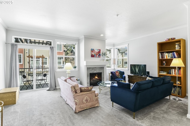 living area featuring carpet floors, a fireplace, and crown molding