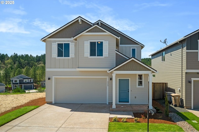 craftsman house with board and batten siding, concrete driveway, and a garage