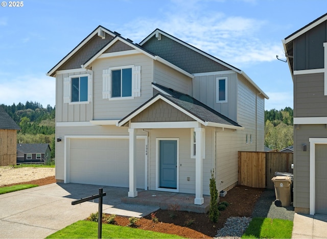 craftsman house with board and batten siding, driveway, a garage, and fence