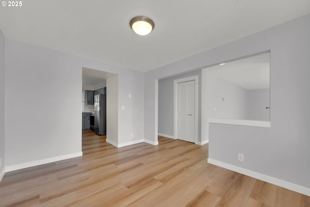 unfurnished room with light wood-type flooring