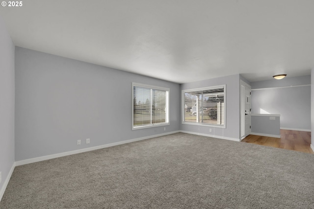 unfurnished living room featuring light colored carpet