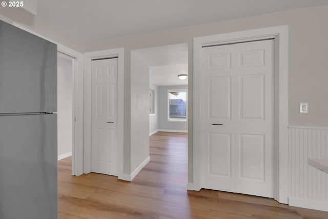 corridor with light wood-type flooring