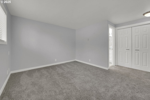 unfurnished bedroom featuring carpet floors and a closet