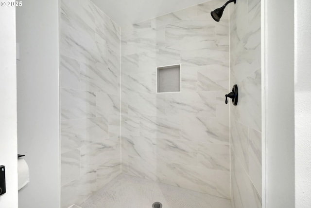 bathroom with tiled shower