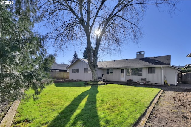 back of house with a lawn