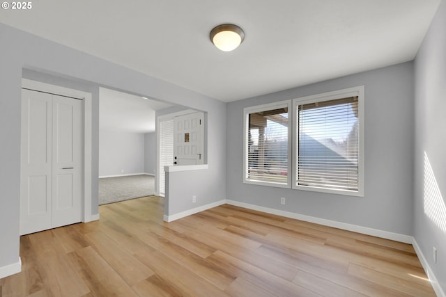 spare room with light hardwood / wood-style flooring