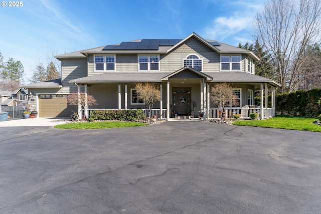 2709 Jerome Prairie Rd, Grants Pass, OR 97527 - view of front facade featuring a porch, asphalt driveway, solar panels, and a garage