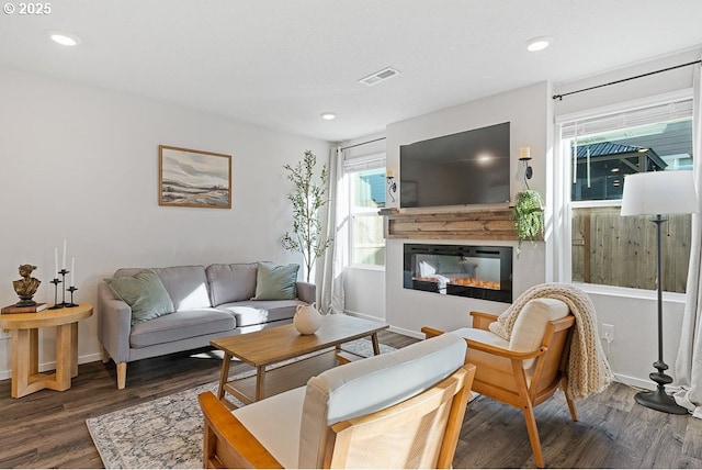 living room featuring dark hardwood / wood-style flooring and a textured ceiling