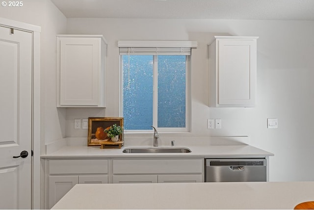 kitchen featuring sink, stainless steel dishwasher, and white cabinets